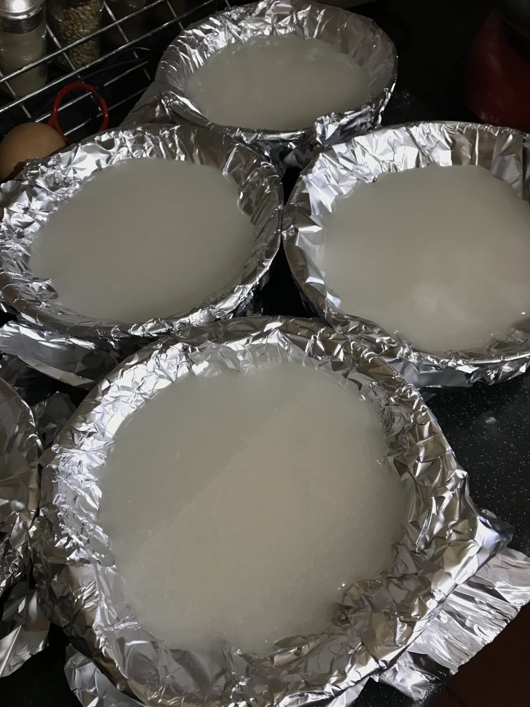 Bowls lines with foil filled with whisked sugar syrup
