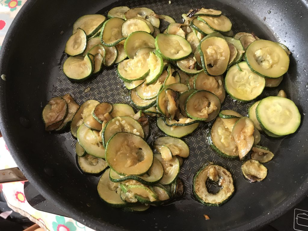 Batch cooking the courgettes slices in a frying pan