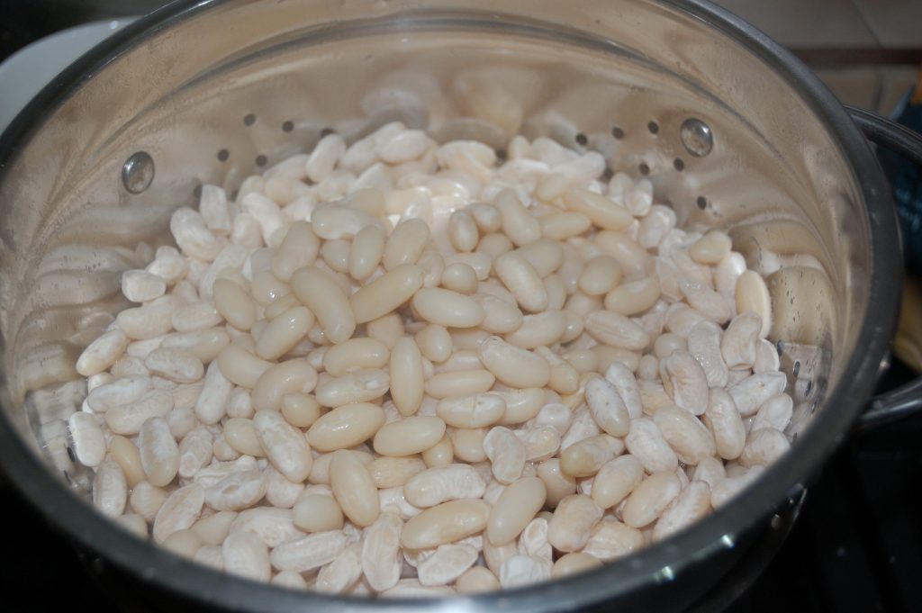 A colander of drained cooked beans