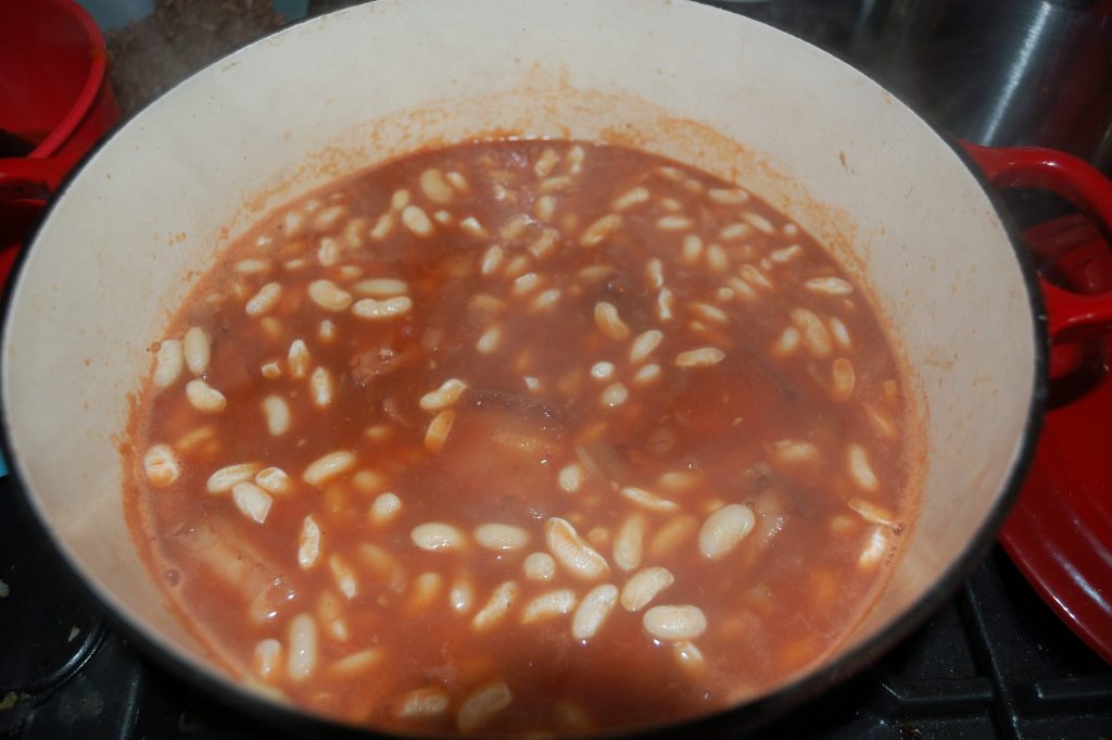 An enameled pan with all the ingredients ready to bake.