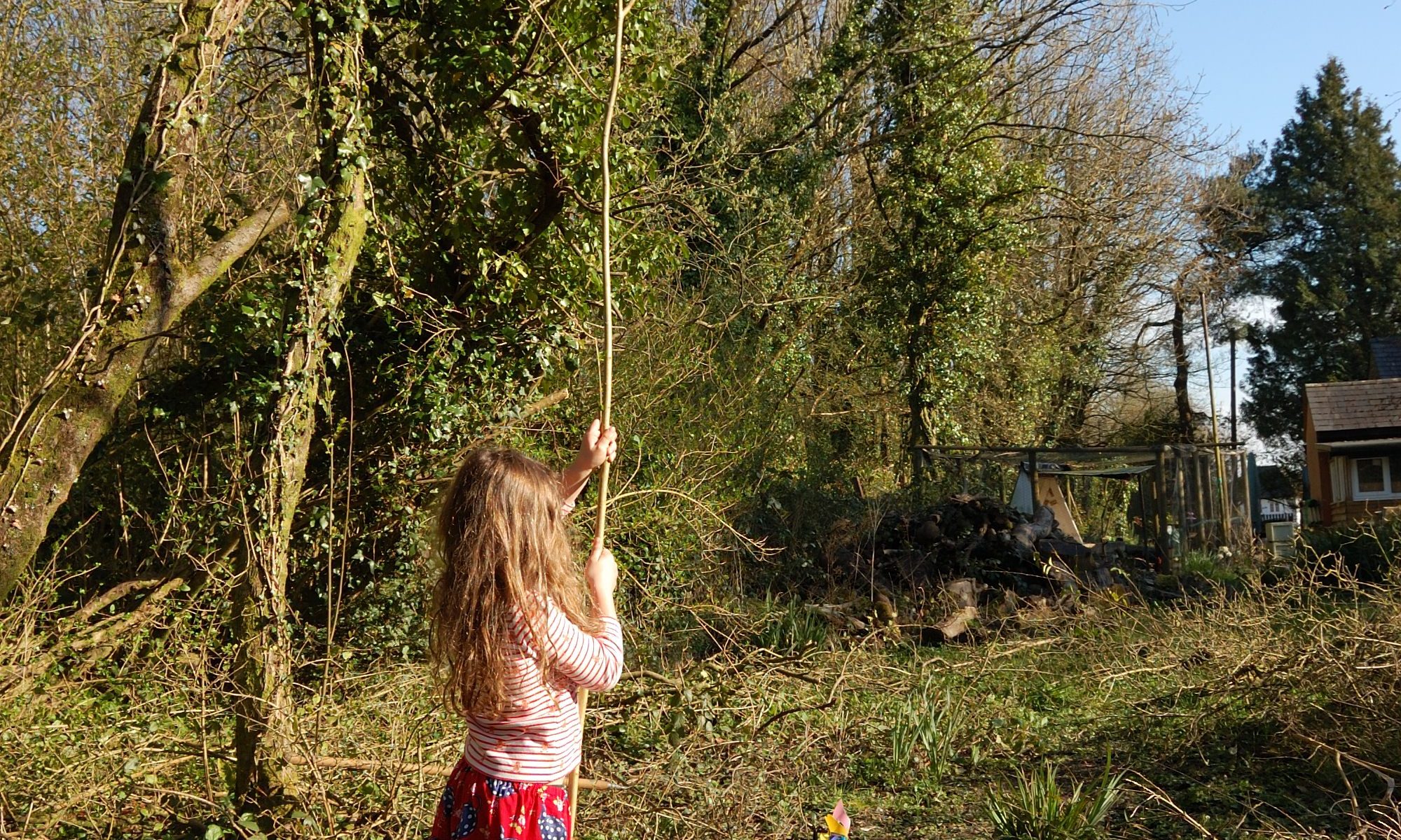 A small monster waving a bit of tree.