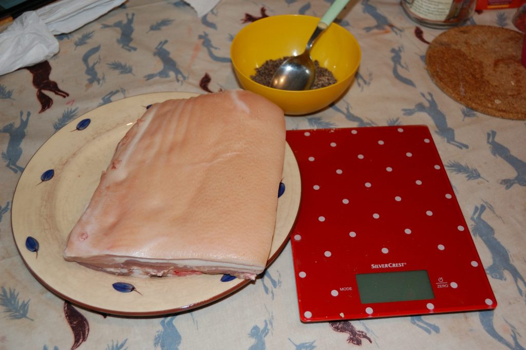 1.5 kg piece of belly pork, lectronic scales and a dry cure rub.