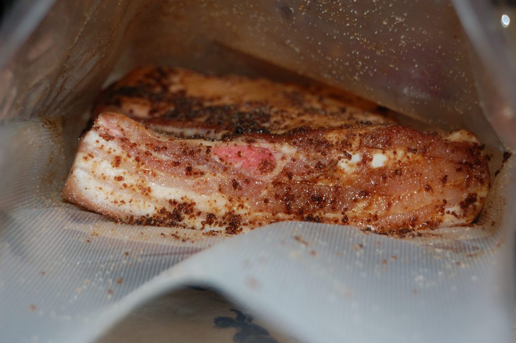 Belly pork in a vacbag covered in cure awaiting sealing