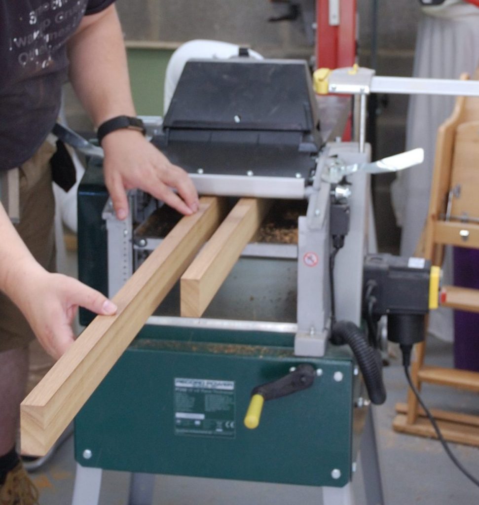 GymCee passing the wood for pan rack through the thicknesser.