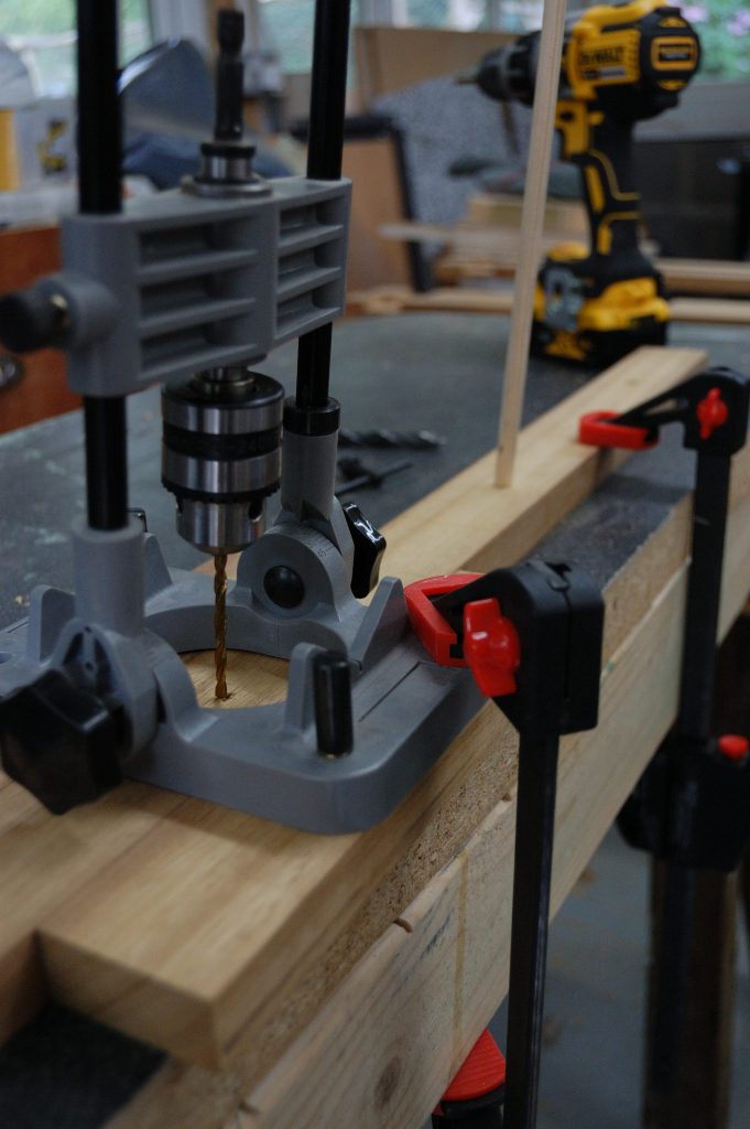 Angled drill holder used to drill holes for pegs