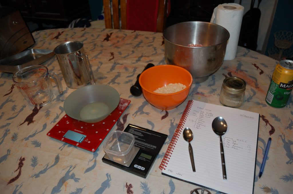 A table with all the equipment and most of the ingredients for making sausages