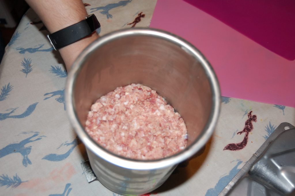 A picture of the filled sausage stuffer ready to go.