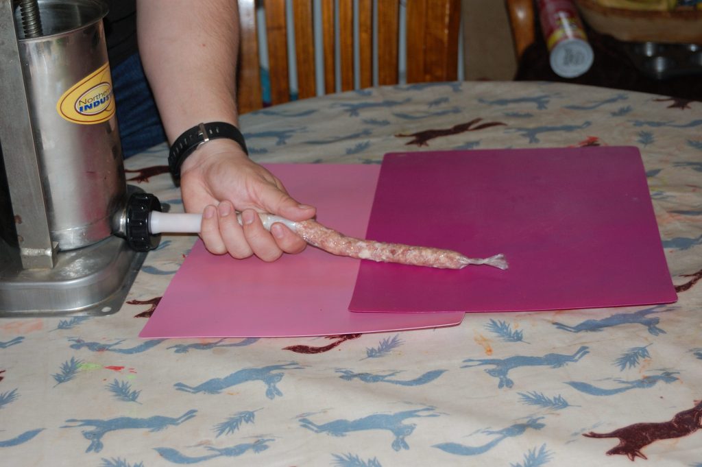 A rather phallic looking process of running the sausages out of the stuffer.