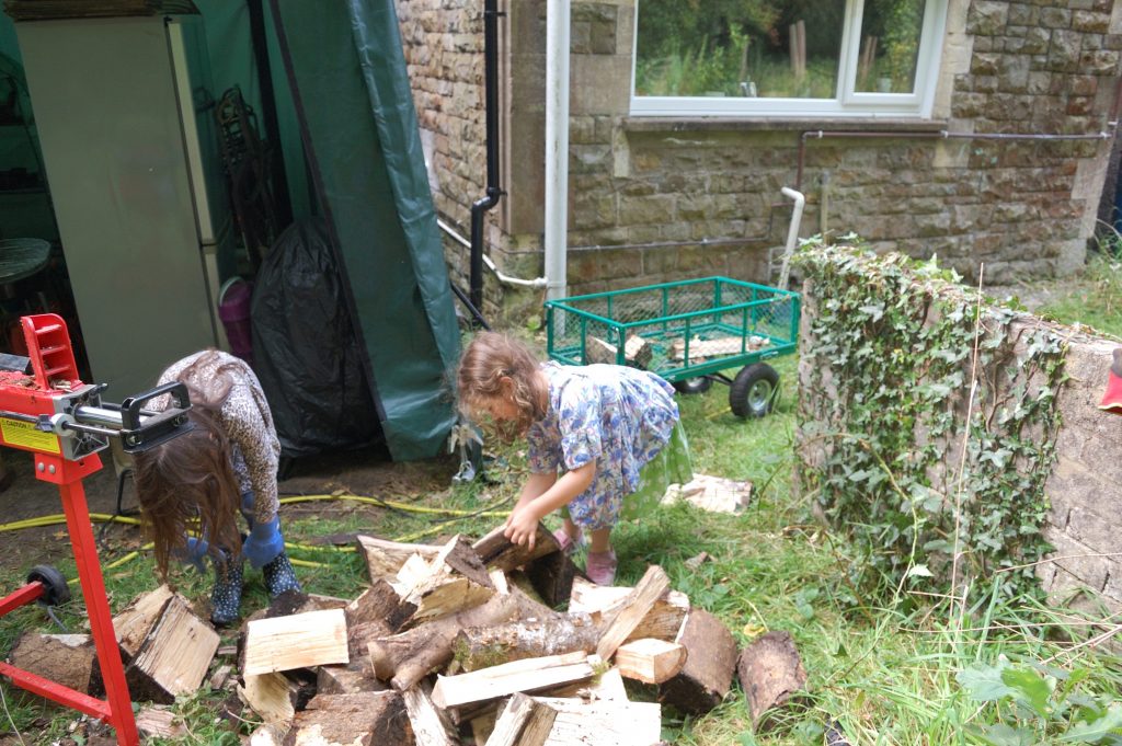 Two monsters loading the split wood to put in the cart.