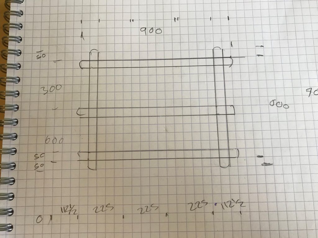 A hand drawn basic plan with dimesions for the pan rack on suqre lined paper.