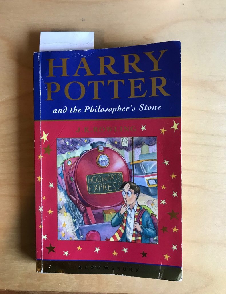 A battered old copy of Harry Potter and The Philosophers Stone