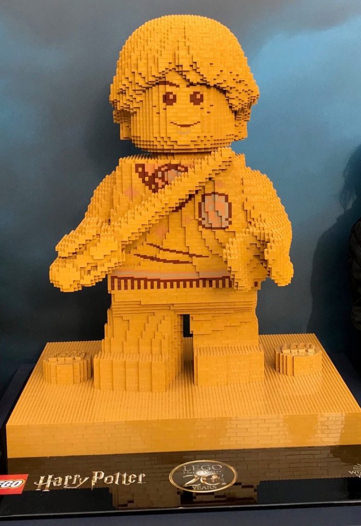 A large golden statue of Ron Weasley made out of Lego