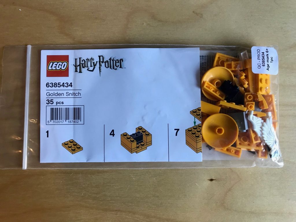 An unopened Lego Harry Potter Golden Snitch set in the bag