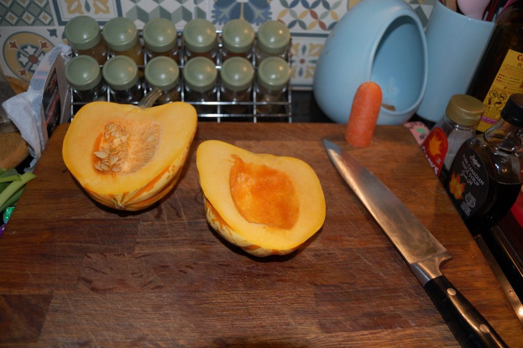 A pumpkin cut in half with one half deseeded.