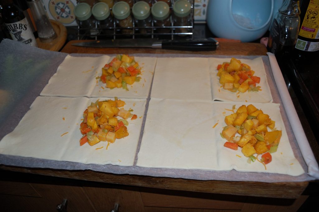 Four half finished savour pumpkin pasties.