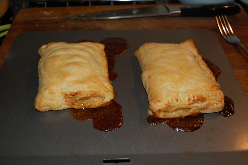 Two pasties oozing sweet juices