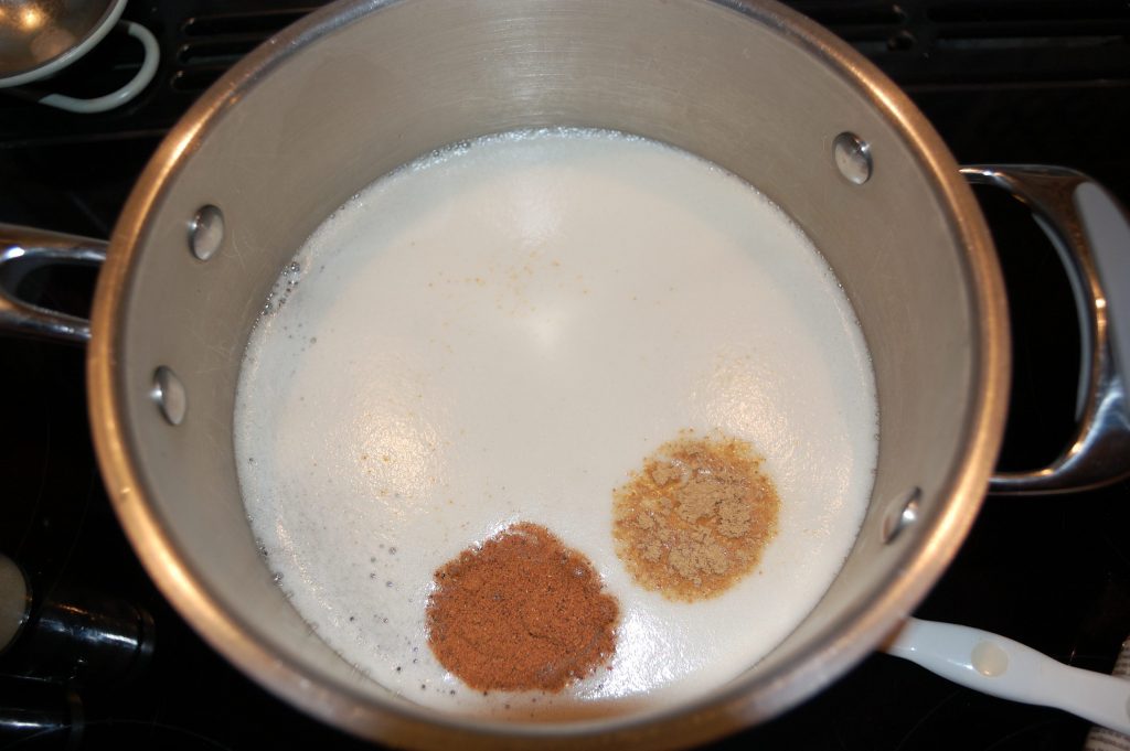 Beer looking like milk with spices floating on top.