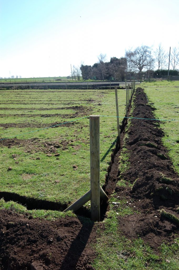 A closer look at a corner post and braces with trench.